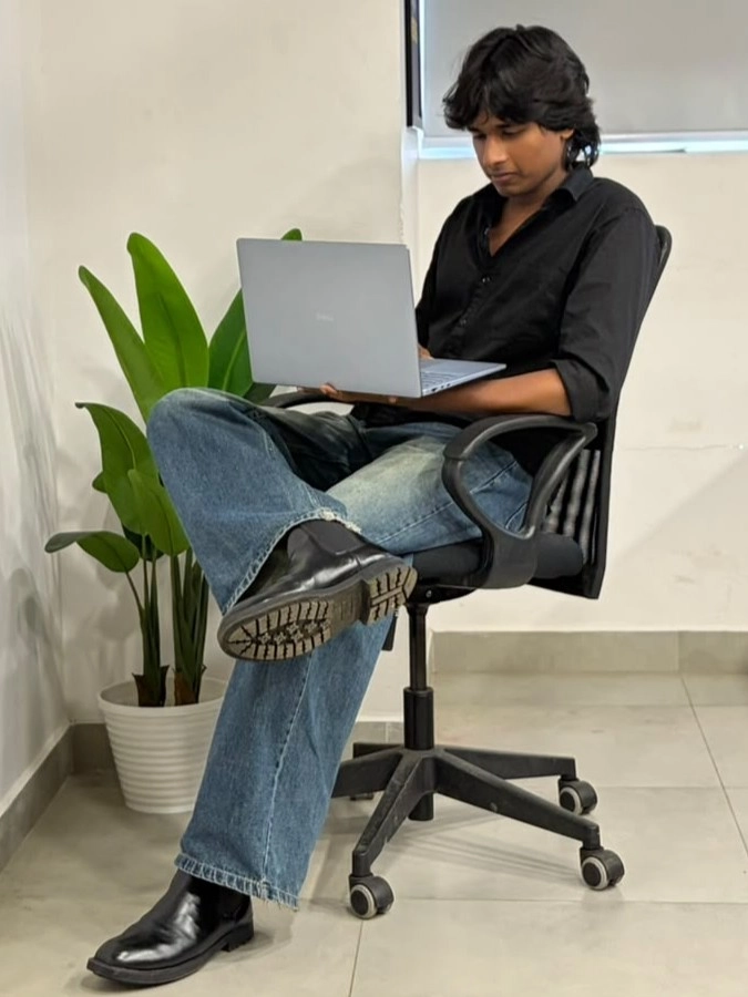 digital marketer sitting on a chair and holding a laptop